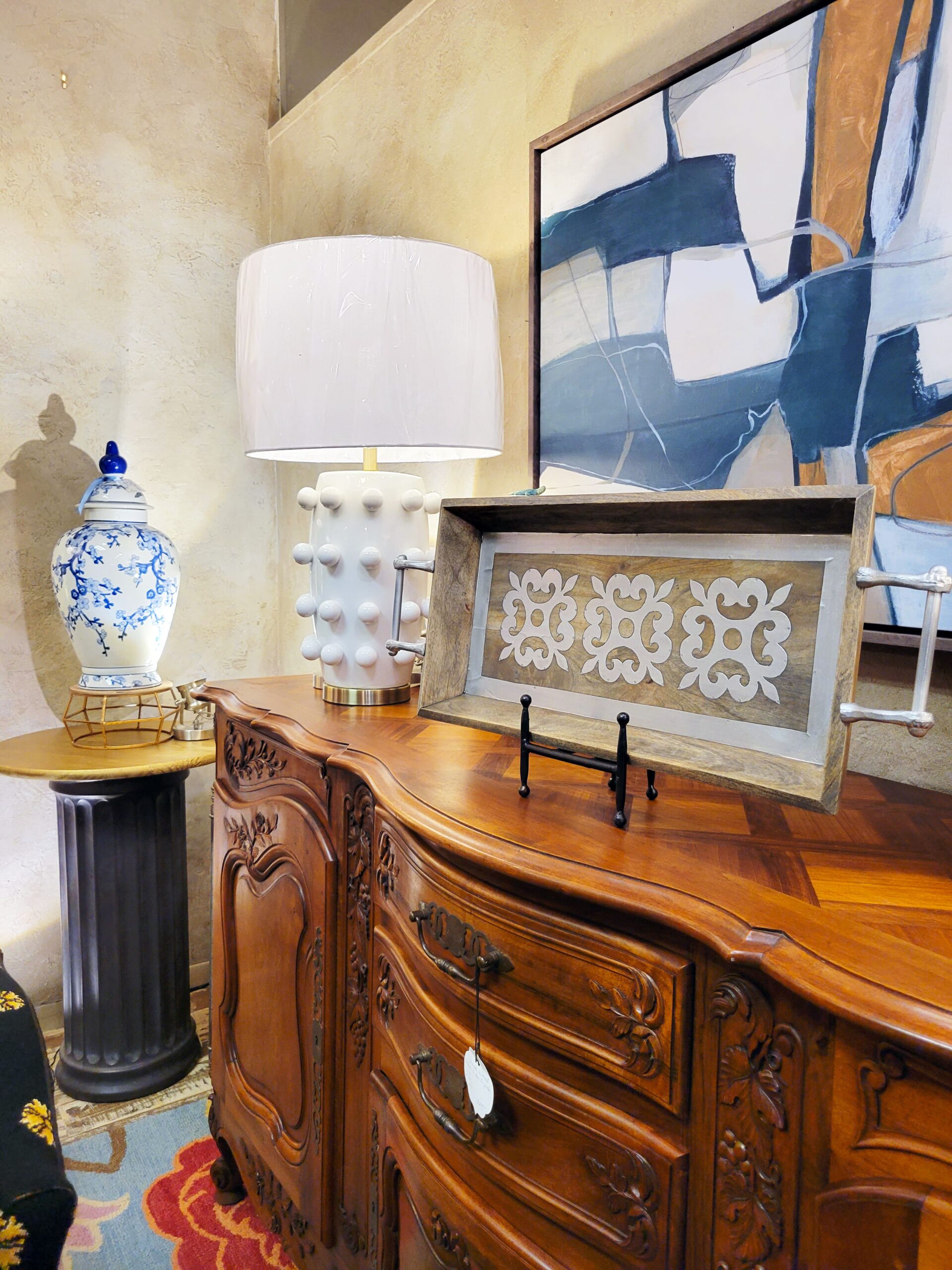 decorative plate with an antique dresser and vase