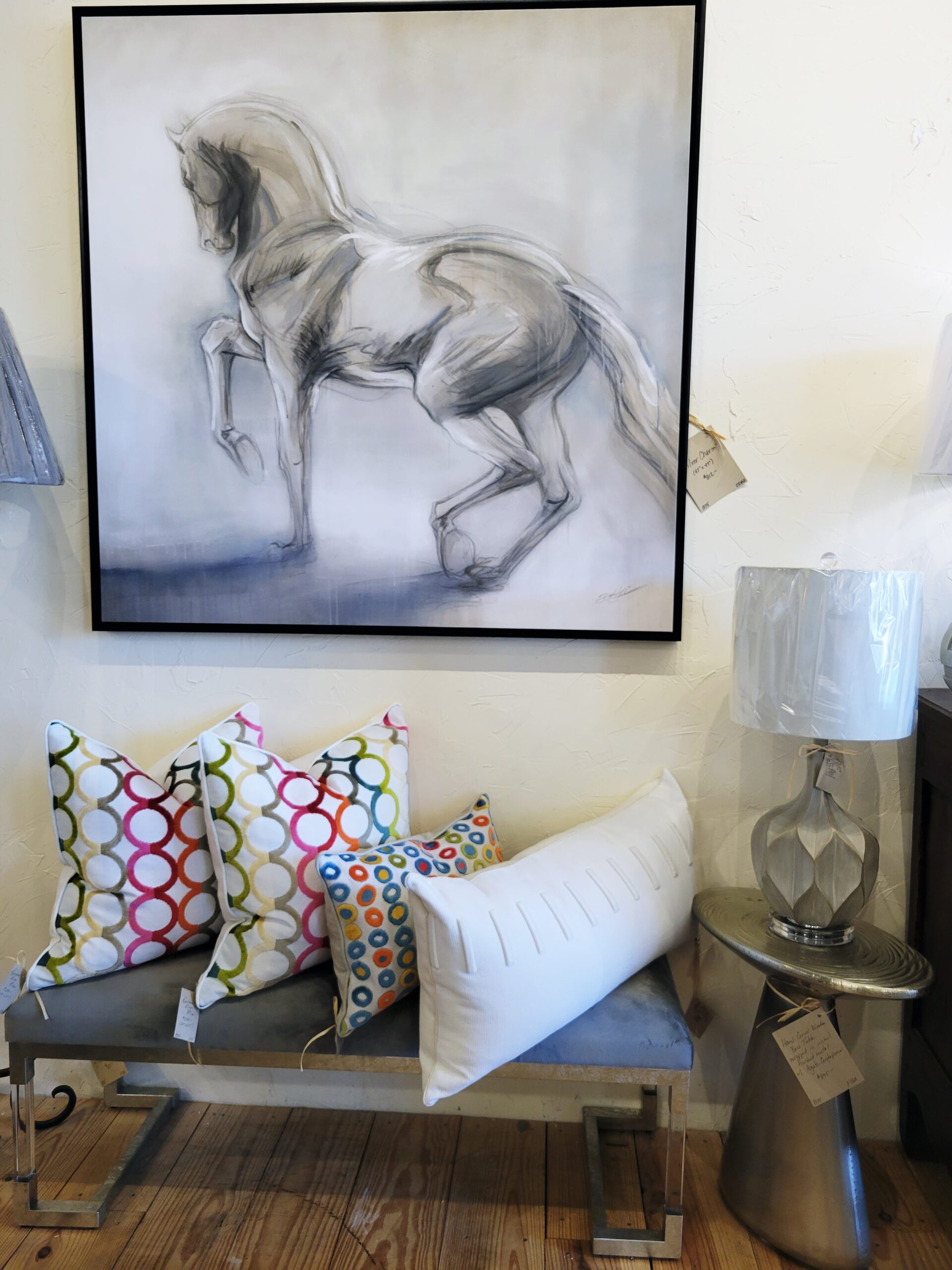 colorful pillows and horse wall art